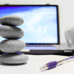 rocks on desk with laptop computer
