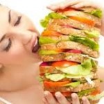 woman eating large sandwich