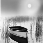 boat on lake in moonlight